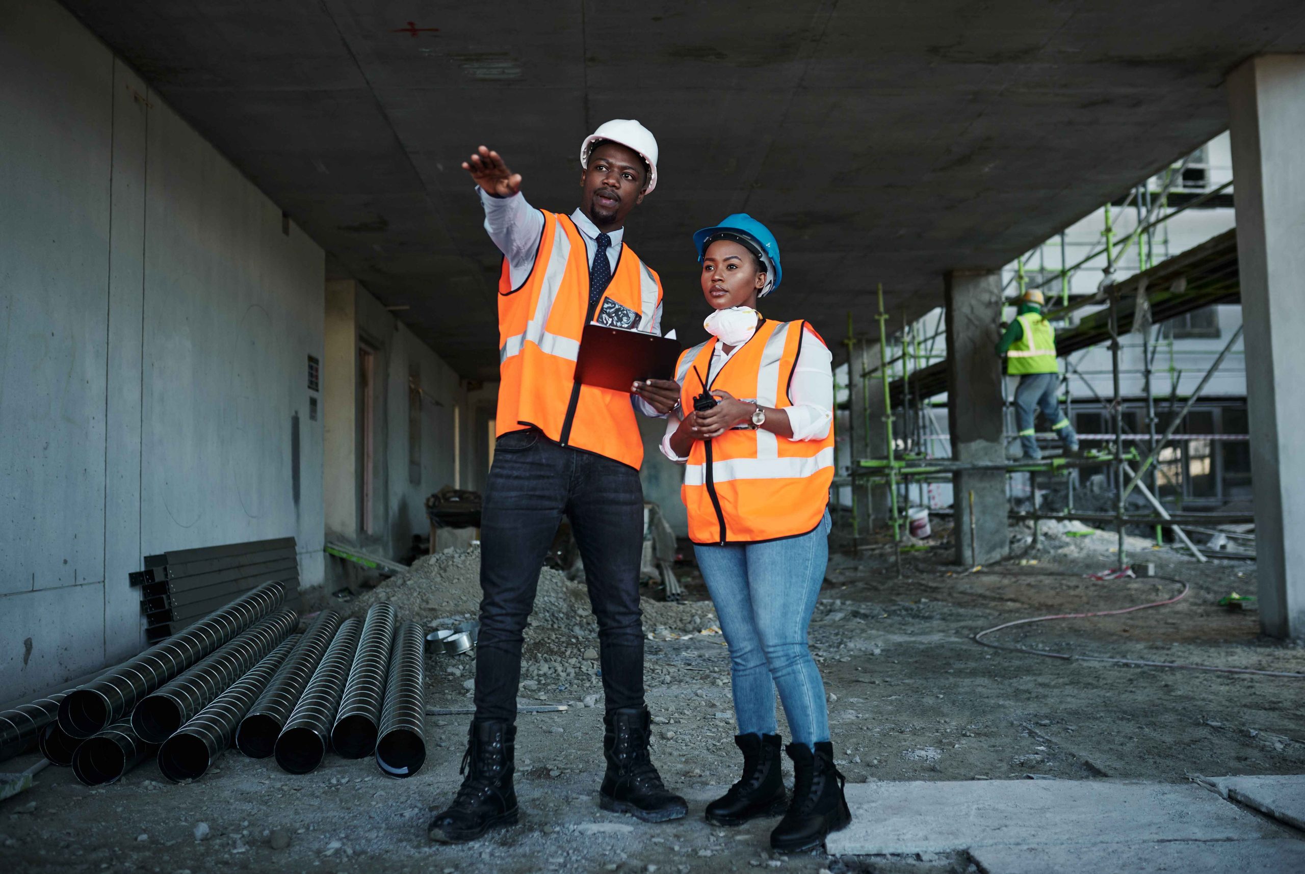 Two construction professionals discussing work at a building site