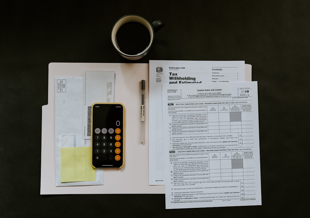 Business owner and accountant reviewing current tax records