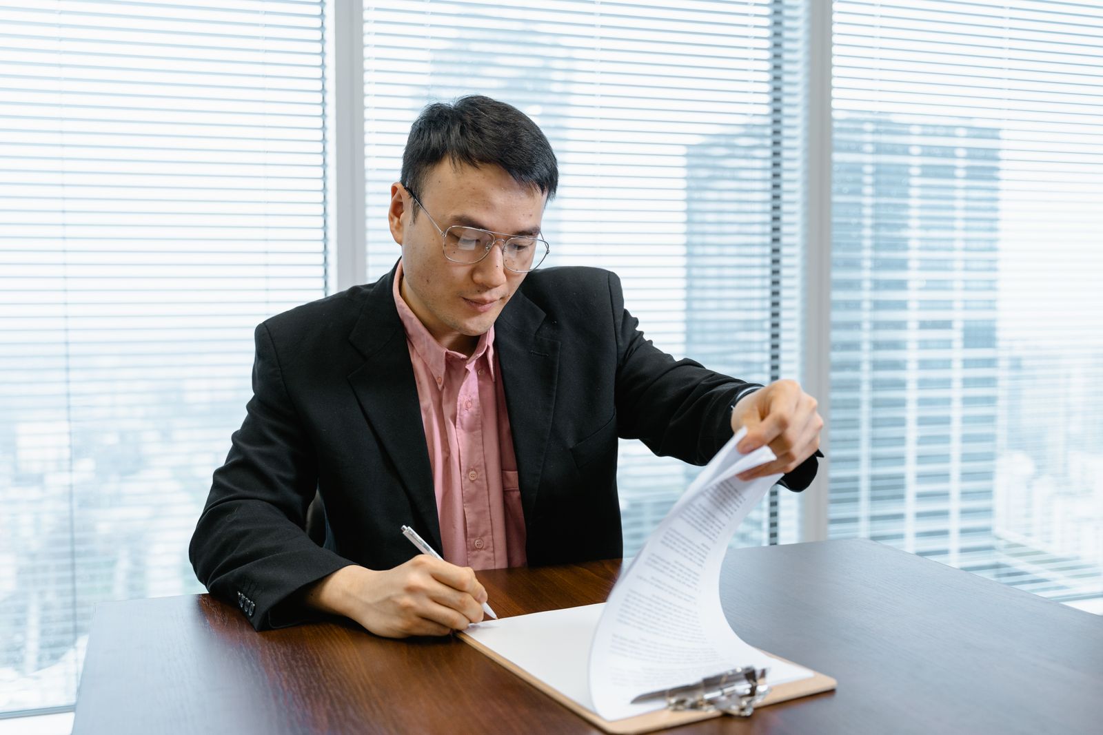 Businessman reviewing paperwork on a clipboard