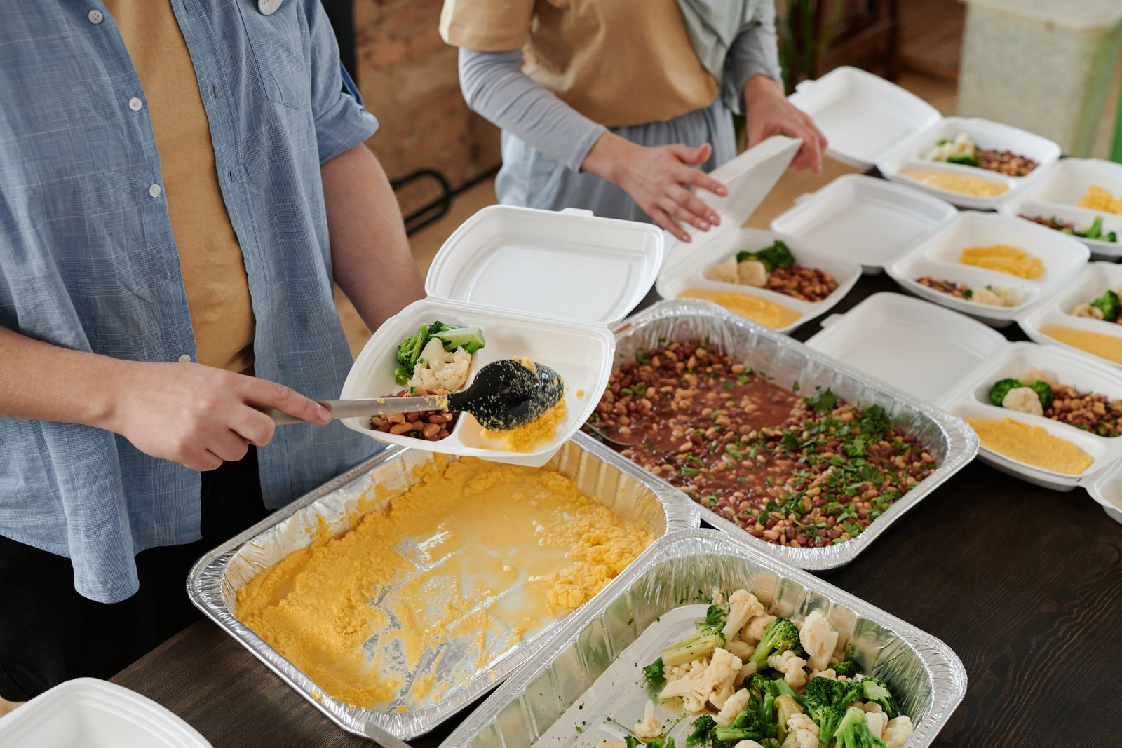 Volunteers preparing food packs in a community kitchen