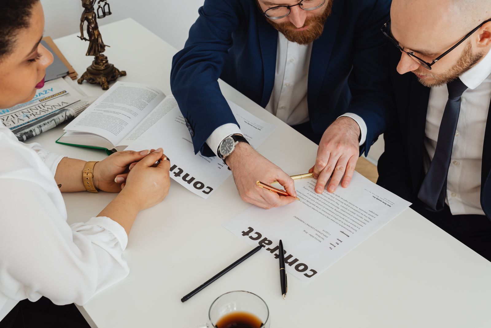 Business colleagues discussing a contract across a desk